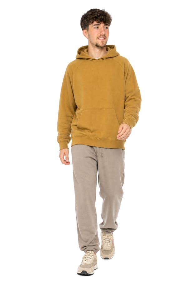 A mustard hoodie with track pants, for an unhurried day.